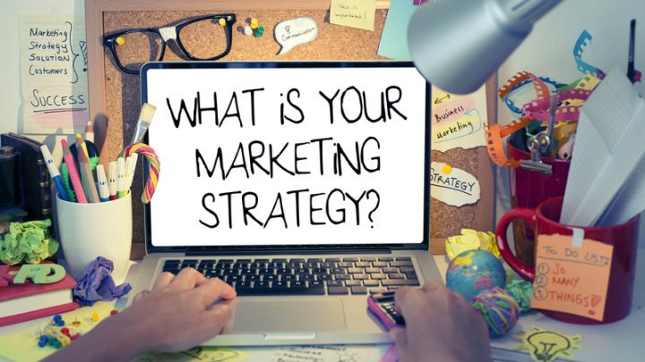 A person working on a laptop in a digital marketing company. "What is your marketing strategy"
