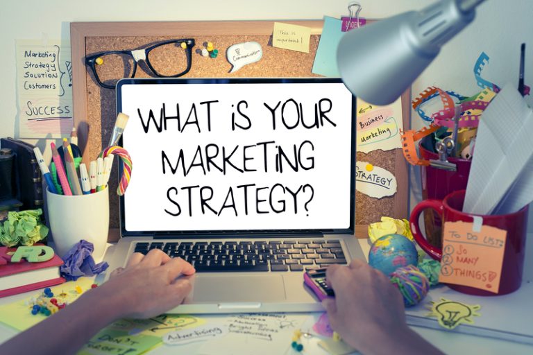 A person working on a laptop in a digital marketing company. "What is your marketing strategy"