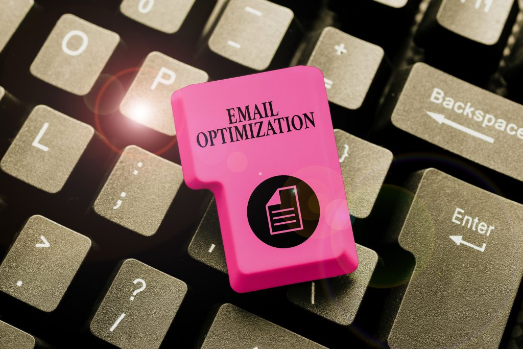 Computer Keyboard with a loose pink key on top of it that has Email optimization written on it