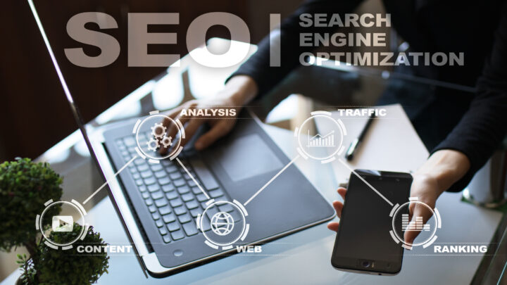 Man working on laptop and mobile in seo company office. virtual icons. SEO, content, web, ranking, search engine optimization