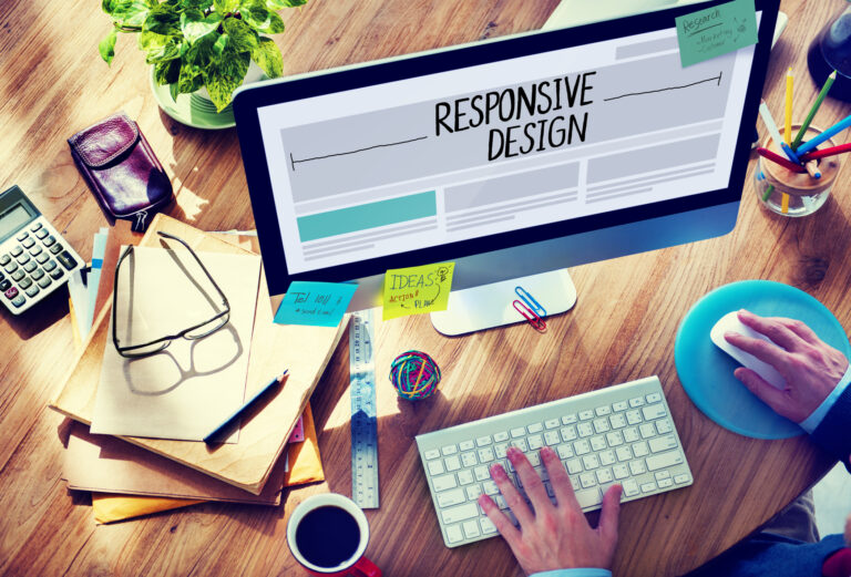 Man working on responsive web design on his computer. Responsive web design.