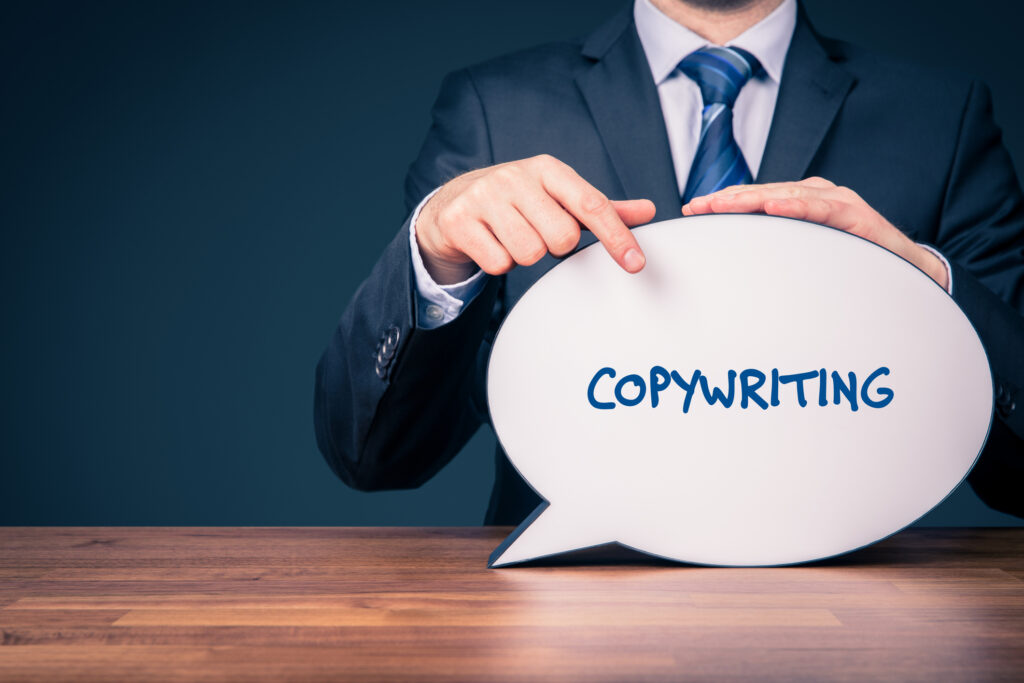 Man in suit pointing to a blurb like object that has copywriting written on it. Copywriting service.