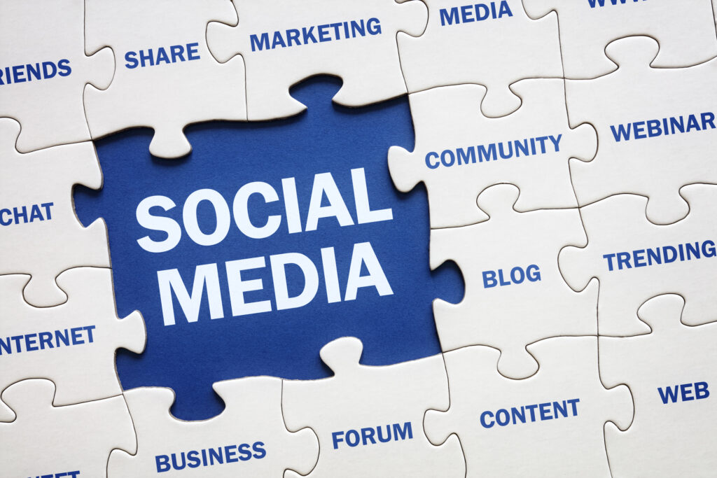 A jigsaw puzzle visual with a center piece saying social media. terms related to social media content services.