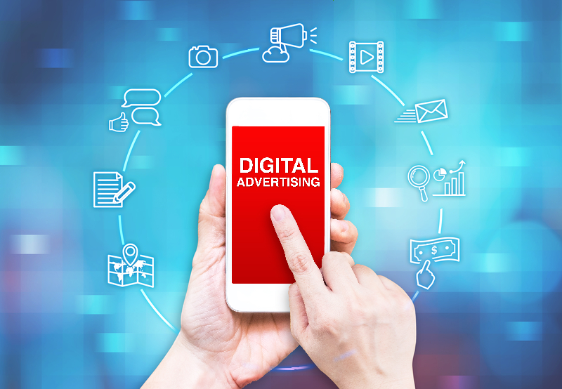 Hand holding smart phone displaying Digital Advertising. Icons of Digital ADs strategy.